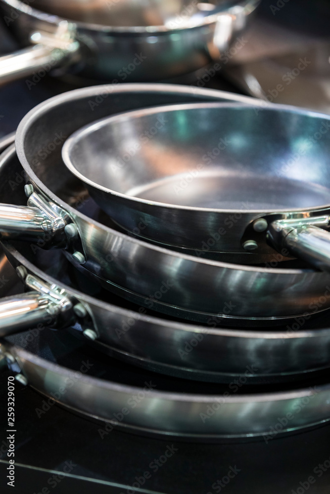 Several new metal pans shot close-up in the kitchen Several new metal pans shot close-up in the kitchen