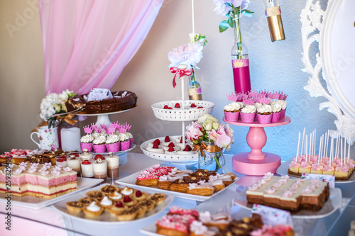 Candy bar with delicious mini cakes, selective focus