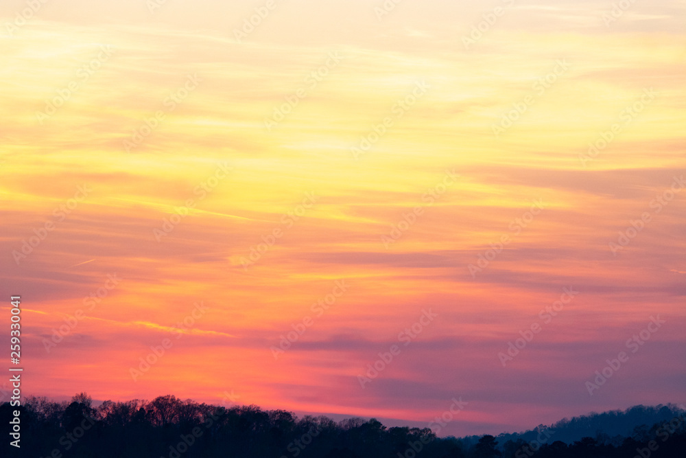 sky and clouds over hills at sunset