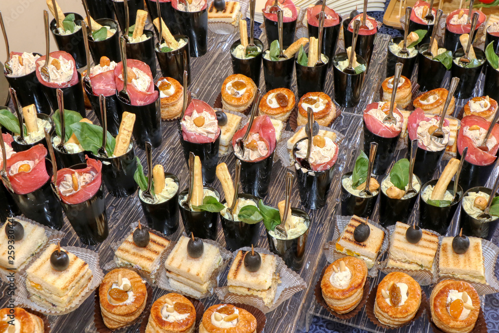 Table set of various appetizers and finger food in a catering Table set of various appetizers and finger food in a catering