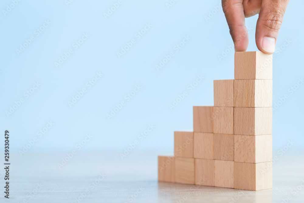 Hand Closer up hands of businessmen,stacking wooden blocks into steps,Concept of business growth success Hand Closer up hands of businessmen,stacking wooden blocks into steps,Concept of business growth success