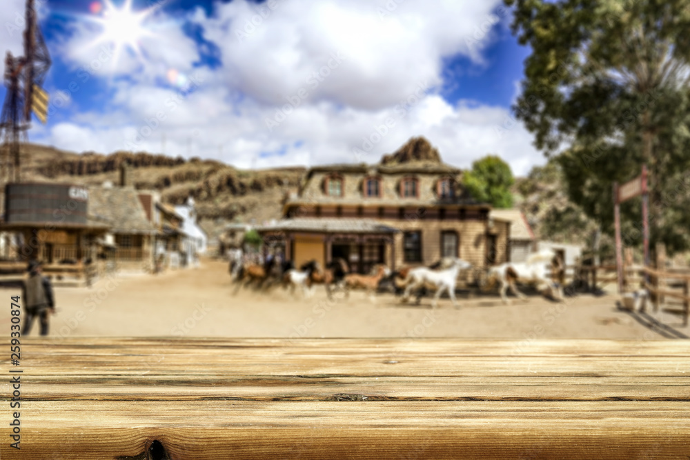 Desk of free space for your decoration. Summer city. Western architecture and running horses Desk of free space for your decoration. Summer city. Western architecture and running horses