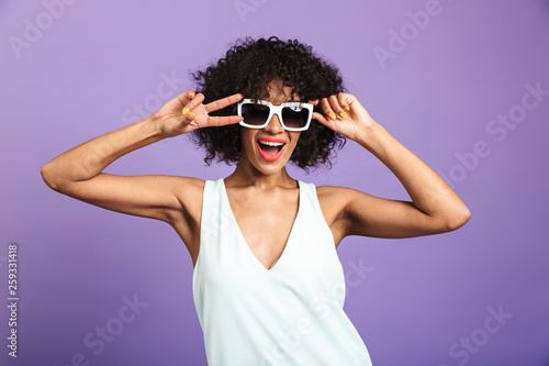 Pleased pretty african woman showing peace gesture