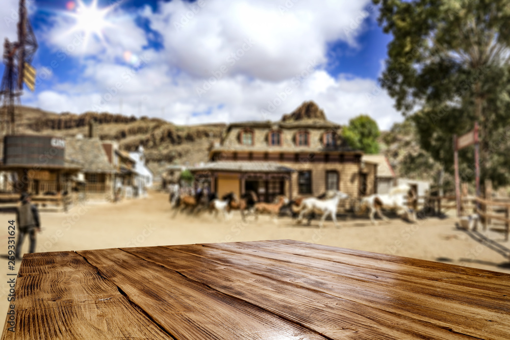 Desk of free space for your decoration. Summer city. Western architecture and running horses Desk of free space for your decoration. Summer city. Western architecture and running horses