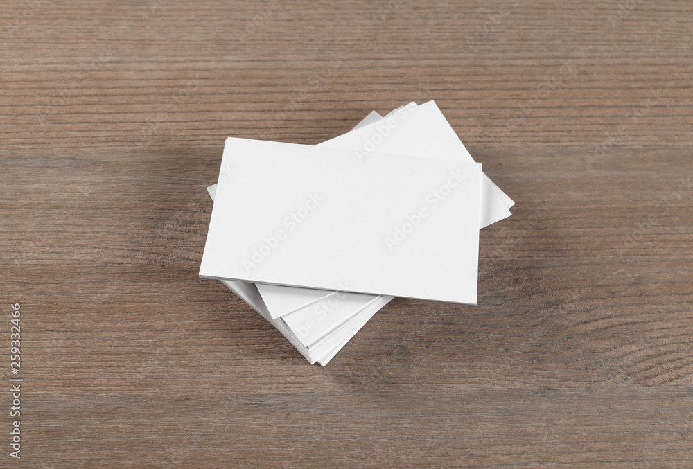 Mockup of blank business cards on wood table background. Mockup of blank business cards on wood table background.