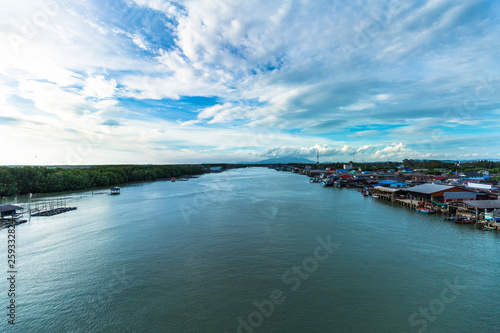 View of boat and sea and city when look from prasae bridge in the evening at rayong province , thailand. © Panichapong