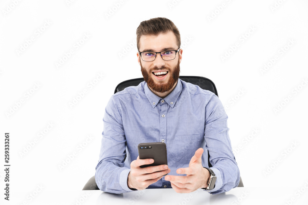 Happy bearded elegant man in eyeglasses using smartphone Happy bearded elegant man in eyeglasses using smartphone