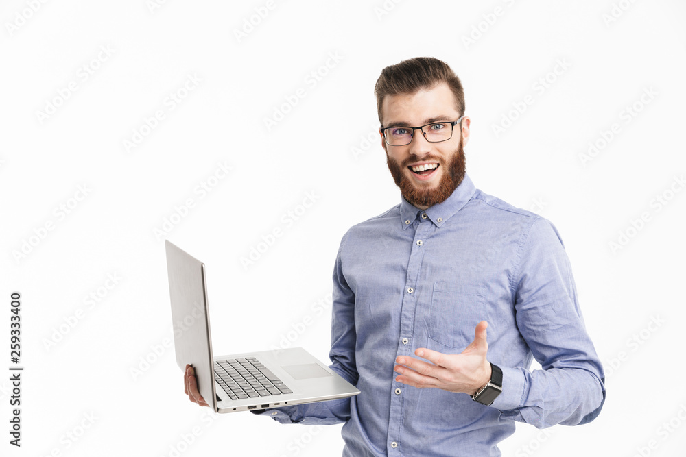 Surprised happy bearded elegant man in eyeglasses holding laptop computer Surprised happy bearded elegant man in eyeglasses holding laptop computer