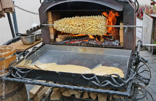 Traditional Lithuanian pie Shakotis baked on an open fire from whipped egg yolks photo