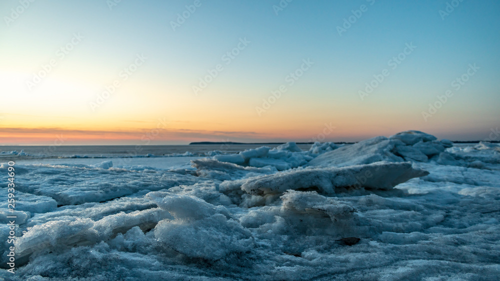 Frozen sea. Snow landscape. Sunset