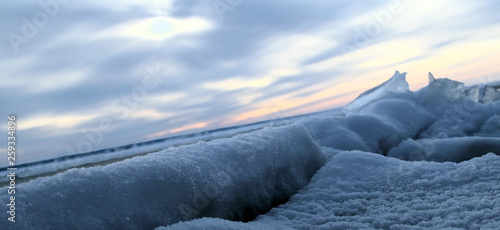 Frozen sea. Snow landscape. Sunset