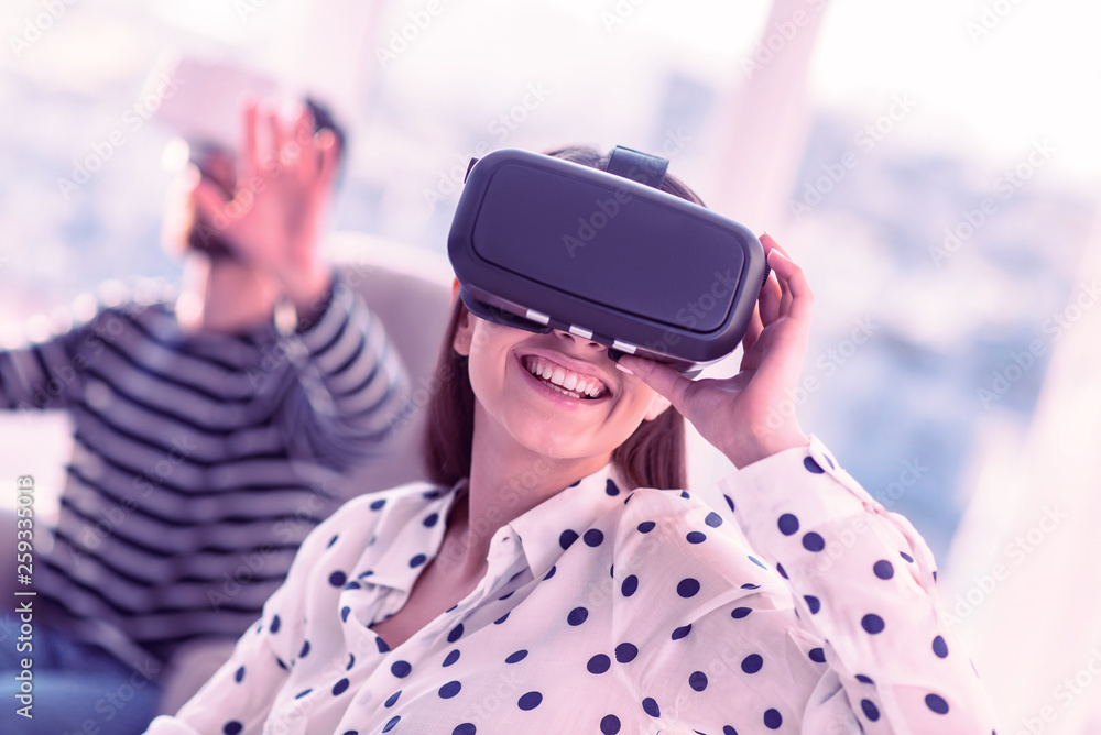 Positive delighted young female testing VR gadget Positive delighted young female testing VR gadget