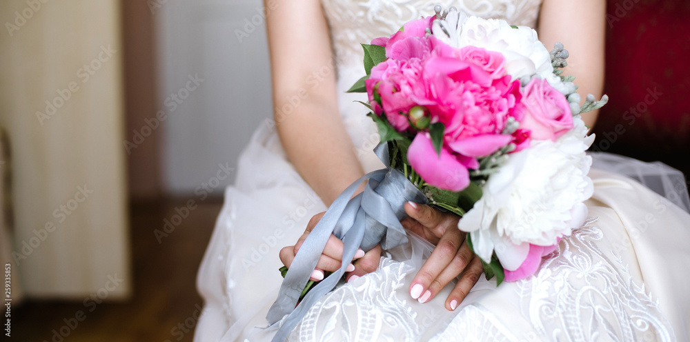 The bride holds a wedding bouquet, close up The bride holds a wedding bouquet, close up