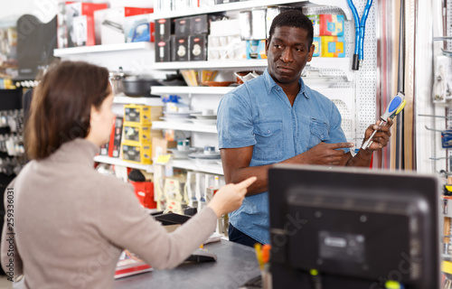 Ordinary salesman offering tools to young woman