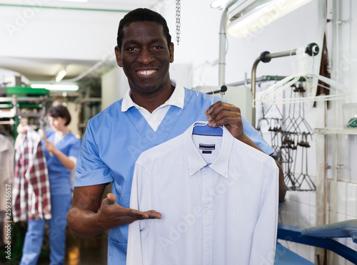 Man worker showing clean clothes