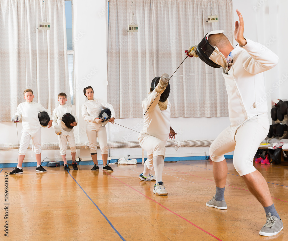 Fototapeta premium Two fencing instructors showing effective techniques