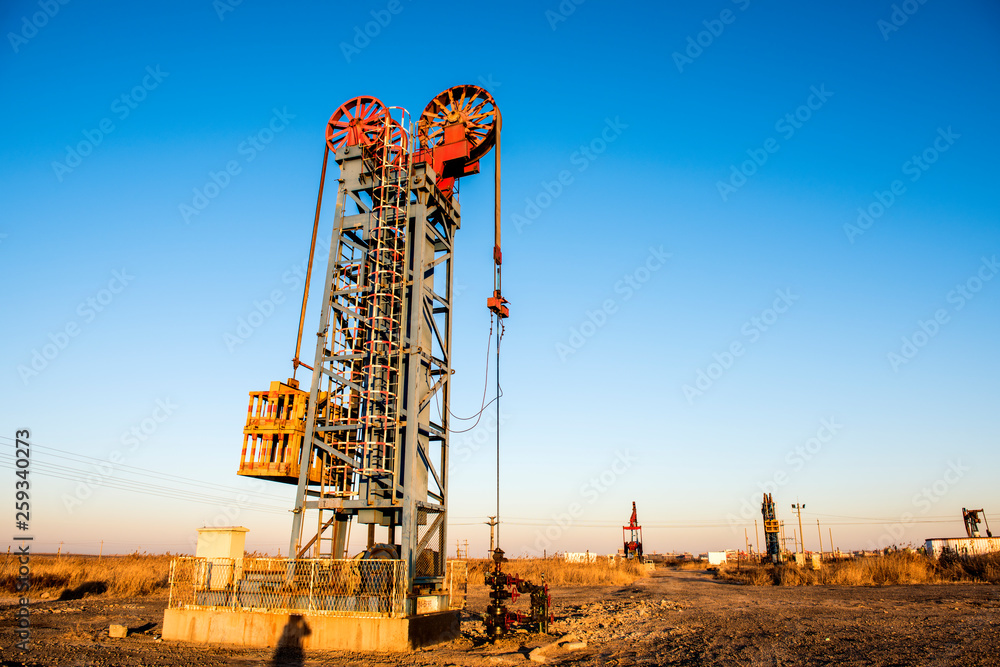 Oil pumps are running in the sunset at the oil field. Oil pumps are running in the sunset at the oil field.