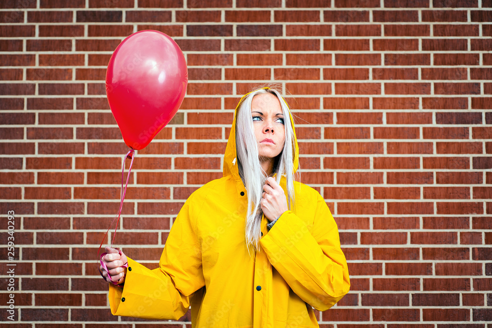 apotek vase halvkugle A girl in a yellow raincoat holding a red balloon on the background of  masonry. Stock Photo | Adobe Stock