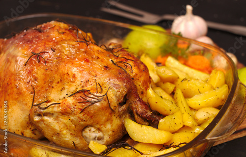 oven-baked crispy crust stuffed chicken on a plate with potatoes, apples, garlic