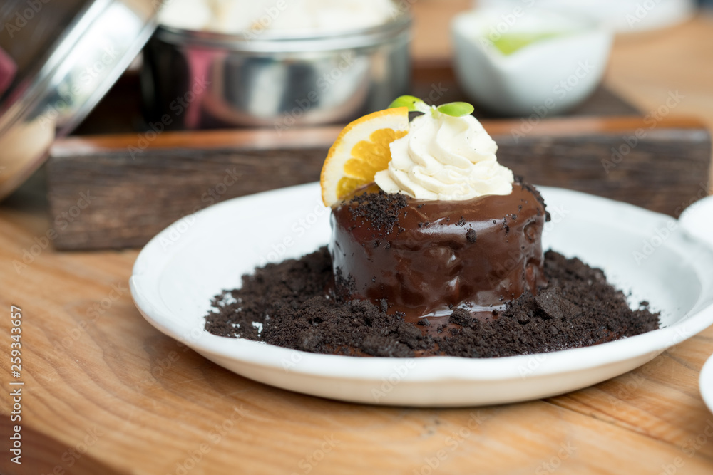 Chocolate lava cake with orange slice and whipping cream Chocolate lava cake with orange slice and whipping cream