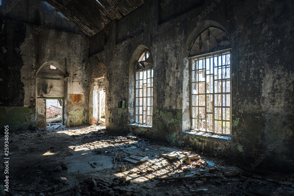 Old abandoned building with broken lancet windows inside 