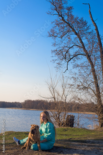 games with a dog breed Shar Pei . by the lake on a spring day © Taranova_ksenya