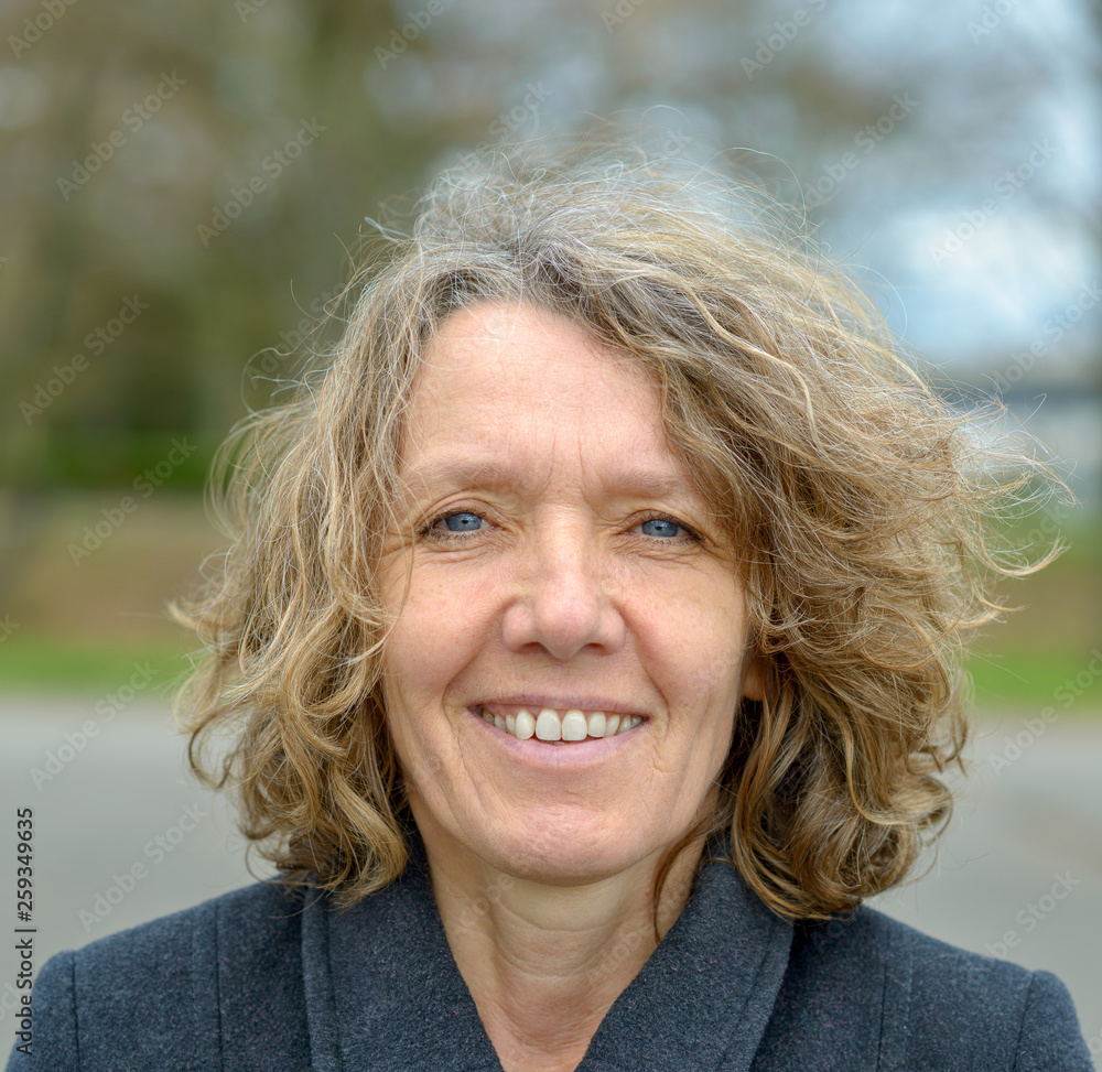Smiling middle aged woman with curly hair Smiling middle aged woman with curly hair