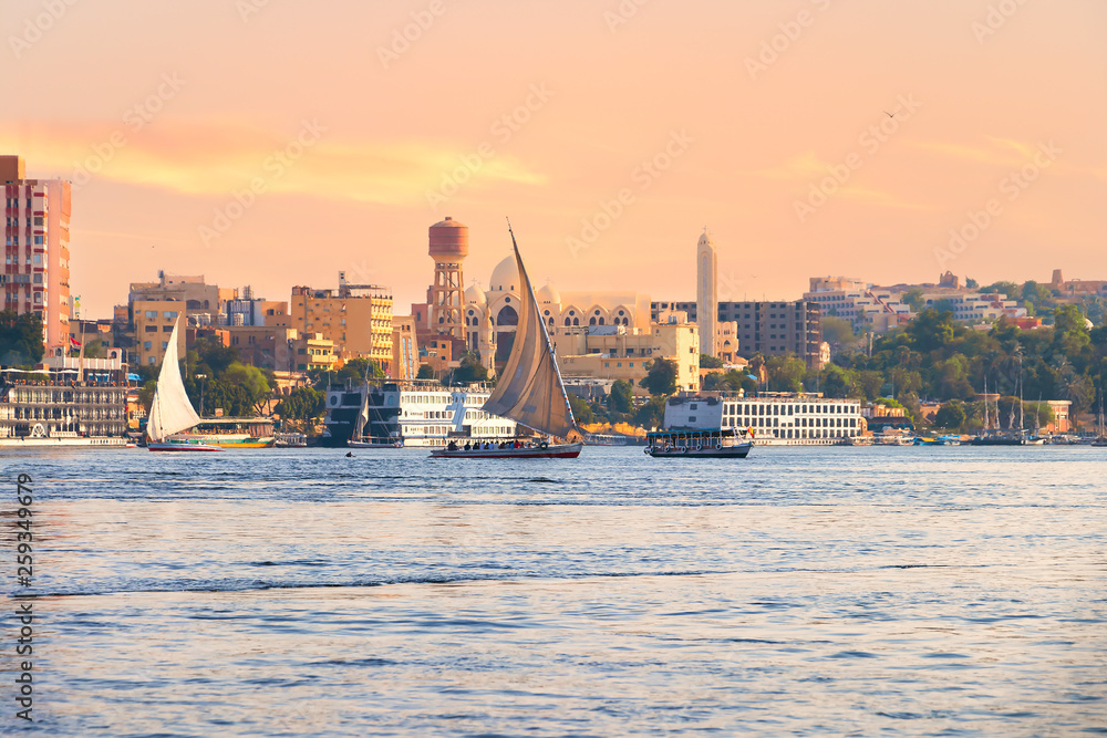 Fototapeta premium Falucas boat and motor boats sailing in Nile river at sunset