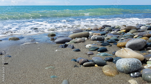 pebbles on the beach, rubble on the seashore, top view, sea wave