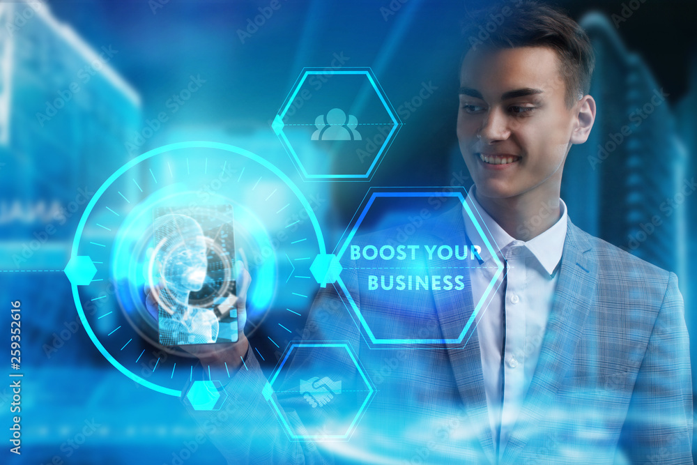 The concept of business, technology, the Internet and the network. A young entrepreneur working on a virtual screen of the future and sees the inscription: Boost your business The concept of business, technology, the Internet and the network. A young entrepreneur working on a virtual screen of the future and sees the inscription: Boost your business