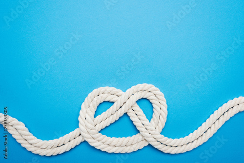 white ropes with sailor knot isolated on blue