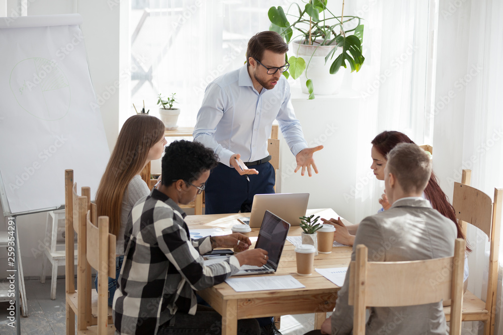 Unsatisfied boss company with employees at boardroom Unsatisfied boss company with employees at boardroom
