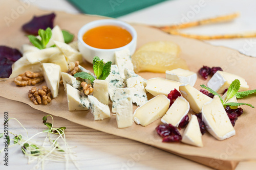 Various types of cheese composition on wooden board