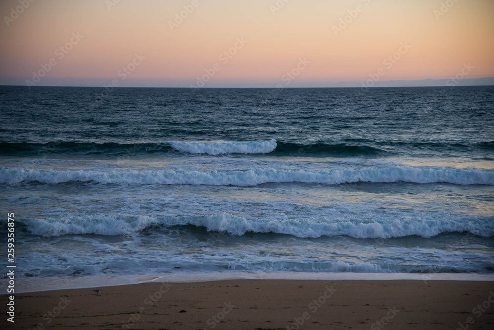 Atlantic ocean, front view of waves on the beach on sunset, Bretagne
