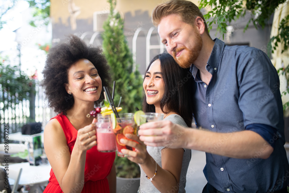 Multiracial group of friends having fun and talking Multiracial group of friends having fun and talking