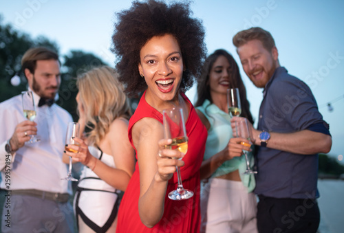 Group of happy people or friends having fun at party