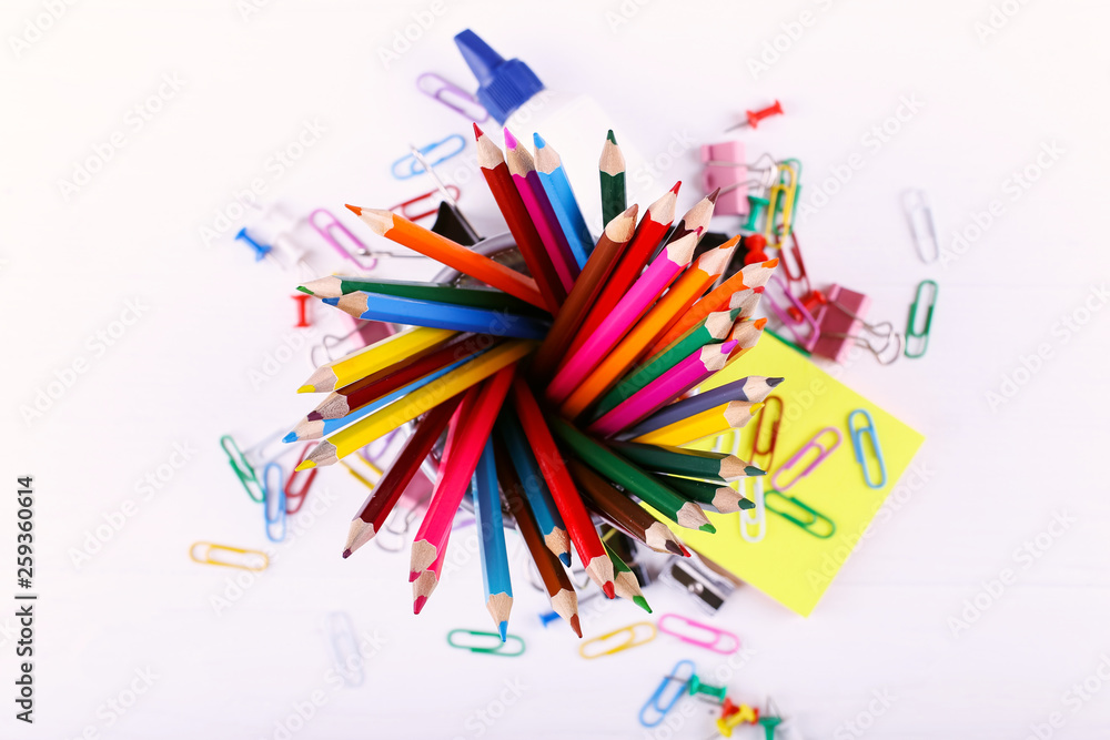 Colored pencils, paper clips and pins, school supplies for drawing, copy space.