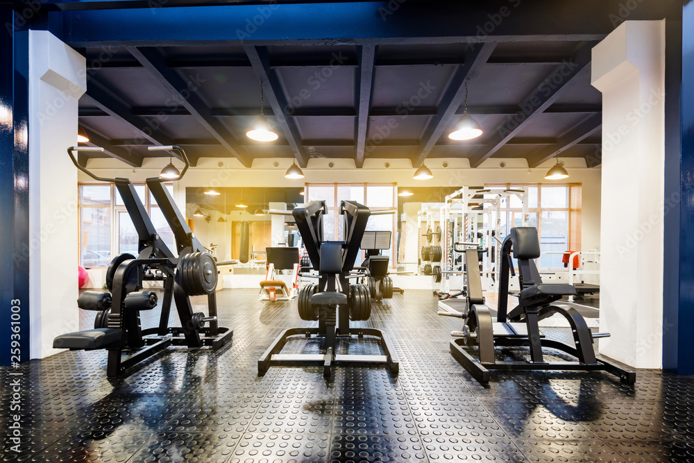 Fototapeta premium New fitness machines in modern gym interior