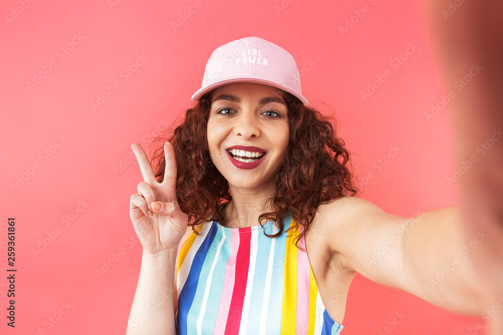 Portrait of a cheerful young woman wearing cap Portrait of a cheerful young woman wearing cap