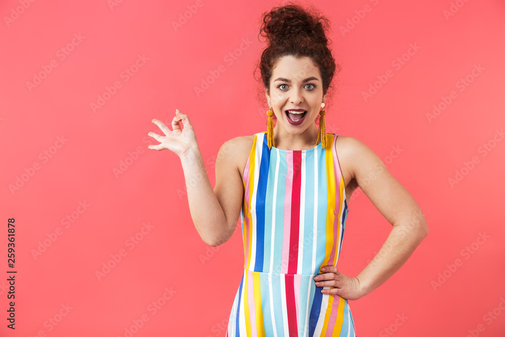Portrait of a cheerful young woman wearing dress Portrait of a cheerful young woman wearing dress
