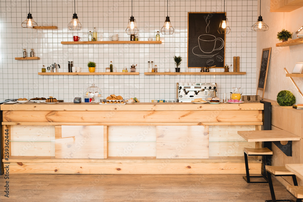 interior of cafeteria with wooden bar counter, shelves and board with drawn coffee cup interior of cafeteria with wooden bar counter, shelves and board with drawn coffee cup