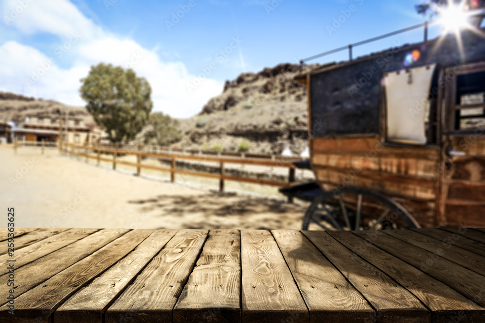 Wooden old table of free space and Wild West background 