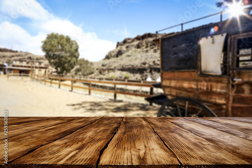 Wooden old table of free space and Wild West background 