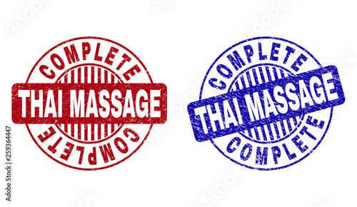 Grunge COMPLETE THAI MASSAGE round stamp seals isolated on a white background. Round seals with grunge texture in red and blue colors.