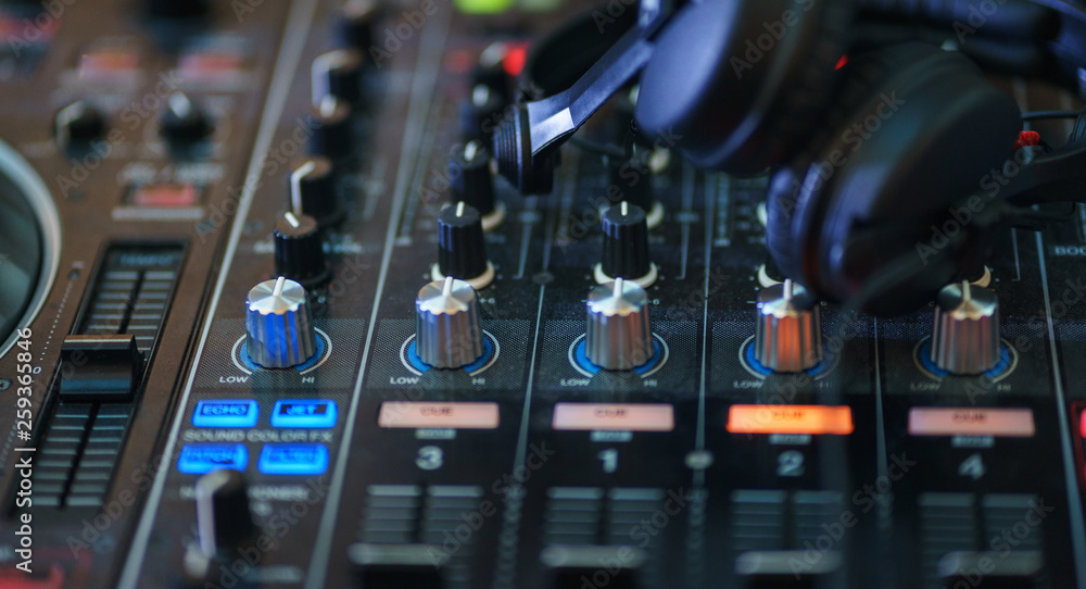 DJ equipment. Player and mixing console with headphones. DJ equipment. Player and mixing console with headphones.