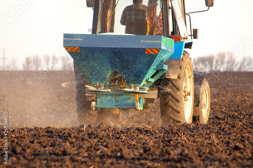 Tractor on the field and makes the fertilizer photo