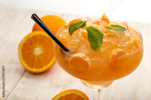 orange fresh cocktail, tangerine decoration. light background