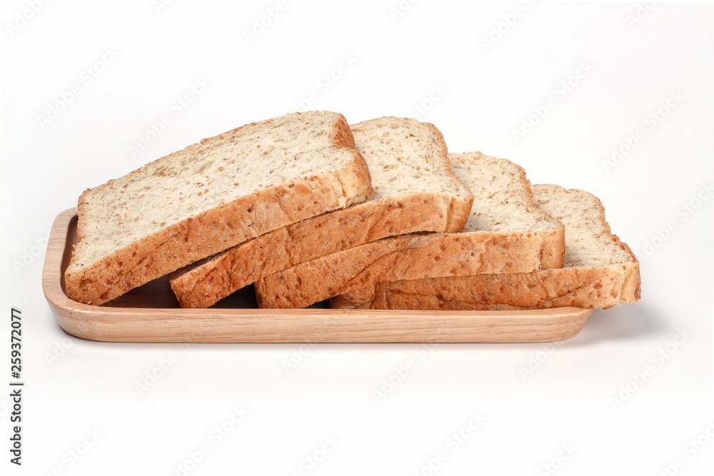 Whole wheat bread. Whole Grain Bread. Toast wheat bread sliced on wooden plate isolated on white background