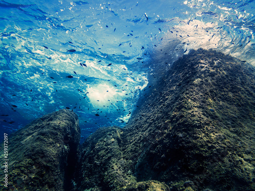 waves beating against the rocks, underwater view