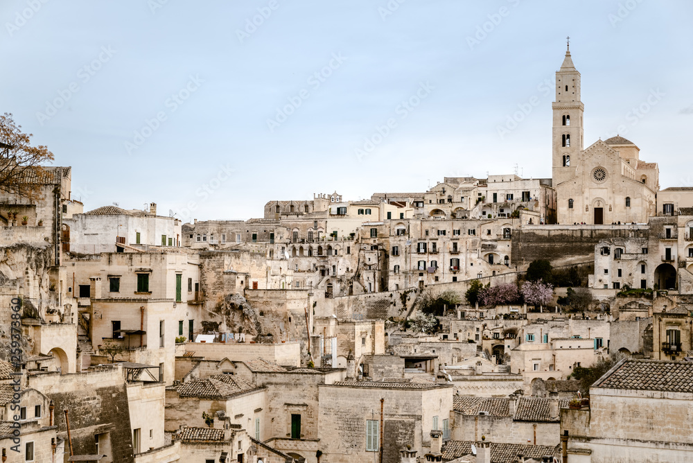 Panoramic view of the city of Matera in Italy, ancient curious village for tourists to be built inside the rocks in caves and stone houses, seen from the top.